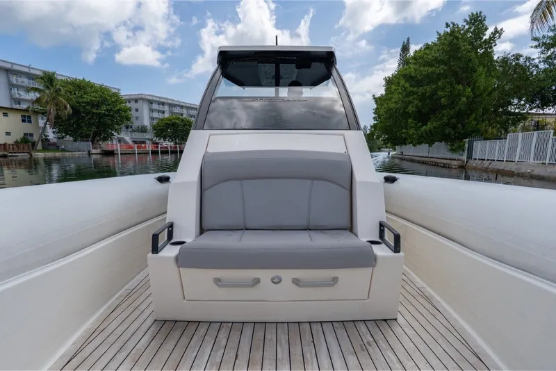 Slide: The Image of 2021 Technohull 38 Grand Sport boat with sleek seating, docked by a canal. - 32