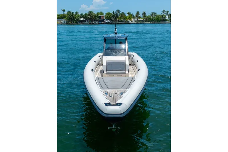 Slide: The Image of 2021 Technohull 38 Grand Sport boat on clear blue water, front view. - 15