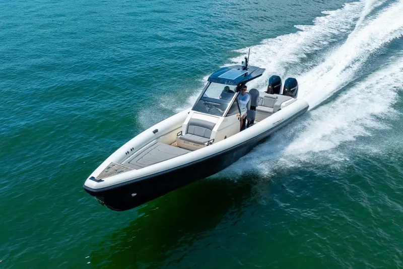 Slide: The Image of 2021 Technohull 38 Grand Sport speeding on open water, showcasing sleek design and performance. - 18