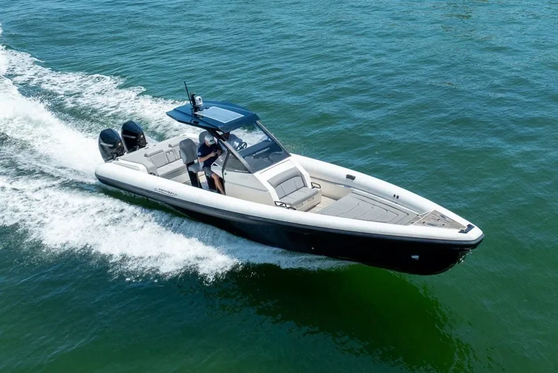 Slide: The Image of 2021 Technohull 38 Grand Sport speeding on water, showcasing sleek design and powerful engines. - 0