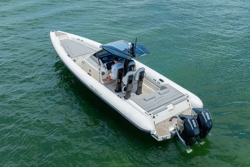 Slide: The Image of 2021 Technohull 38 Grand Sport boat on water, featuring dual engines and sleek design. - 3