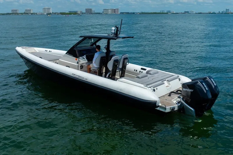 Slide: The Image of 2021 Technohull 38 Grand Sport boat on water, featuring sleek design and powerful engines. - 12