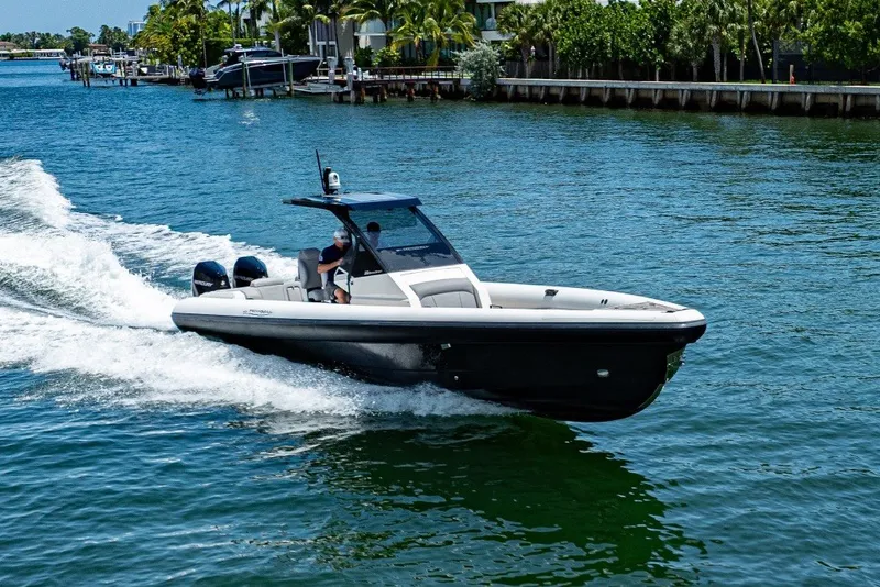 Slide: The Image of 2021 Technohull 38 Grand Sport speeding on a sunny waterway. - 24