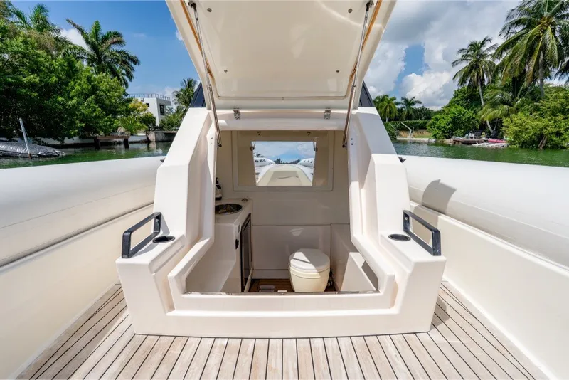 Slide: The Image of 2021 Technohull 38 Grand Sport boat interior with open hatch, showcasing sleek design. - 28