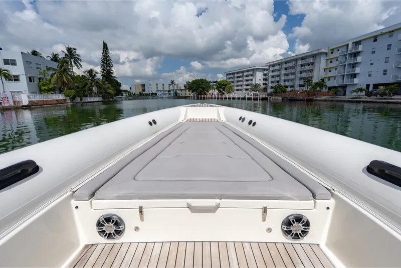 Slide: The Image of Technohull 38 Grand Sport 2021 boat on calm water, surrounded by modern buildings. - 38
