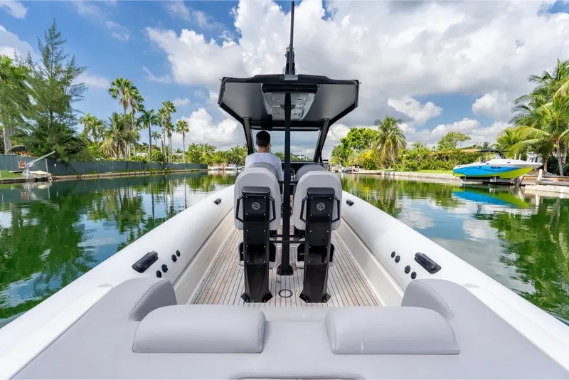 Slide: The Image of 2021 Technohull 38 Grand Sport boat cruising on a scenic, tropical waterway. - 27