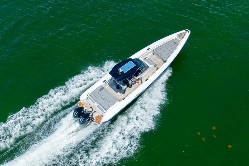 Slide: The Image of 2021 Technohull 38 Grand Sport cruising on vibrant green water. - 26