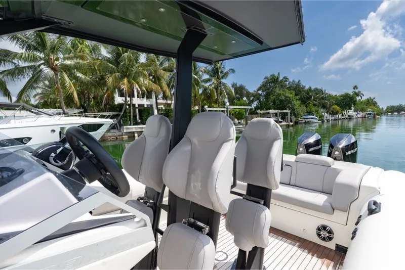 Slide: The Image of 2021 Technohull 38 Grand Sport boat interior with luxury seating and scenic waterfront view. - 33