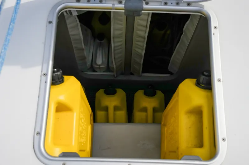 Slide: The Image of Yellow fuel containers stored in a Balance 482 boat compartment, 2022 model. - 77
