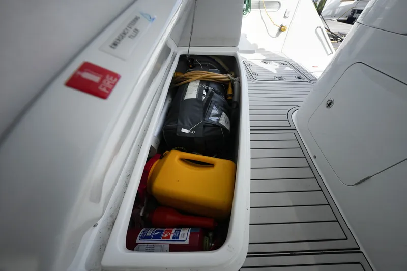 Slide: The Image of Storage compartment on a 2022 Balance 482 boat with safety equipment and supplies. - 75