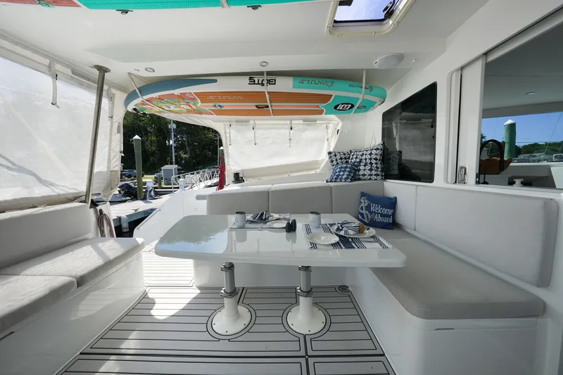 Slide: The Image of Luxurious 2022 Balance 482 yacht interior with dining area and paddleboards. - 10