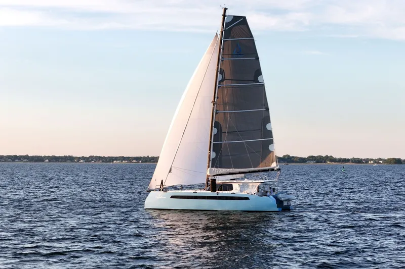 Slide: The Image of Sailing catamaran Balance 482, 2022 model, gliding on calm waters at sunset. - 4