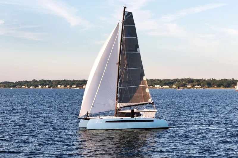 Slide: The Image of Sailing catamaran Balance 482, 2022 model, gliding on serene waters under clear skies. - 83
