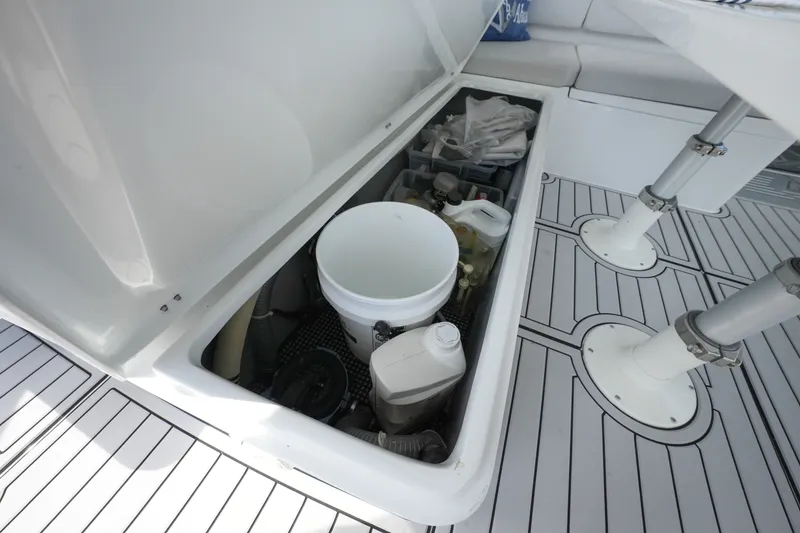 Slide: The Image of Open storage compartment on 2022 Balance 482 boat with cleaning supplies and equipment. - 71