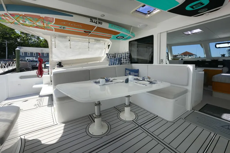 Slide: The Image of Modern yacht interior with dining area, surfboards, and stylish decor, Balance 482, 2022 model. - 11