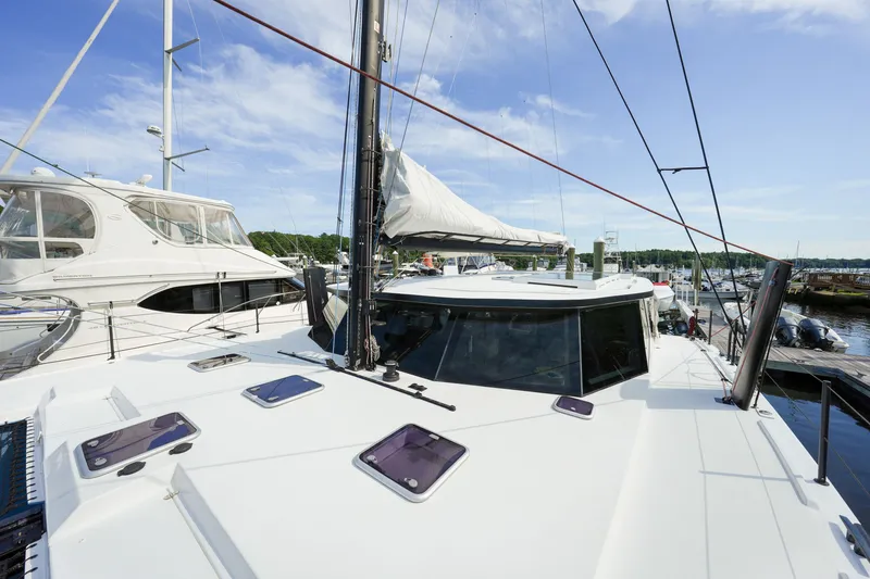 Slide: The Image of Sailboat Balance 482, 2022 model, docked at marina under clear blue sky. - 60