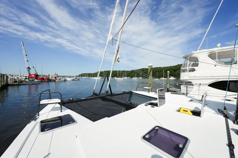 Slide: The Image of 2022 Balance 482 catamaran docked at a marina with clear blue skies. - 62