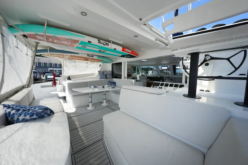 Slide: The Image of Luxurious interior of 2022 Balance 482 yacht with seating and surfboards. - 20