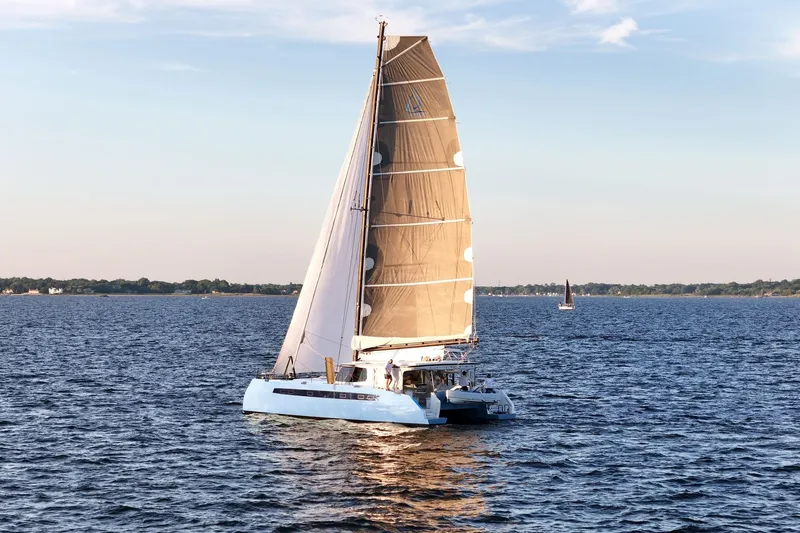 Slide: The Image of Sailing catamaran Balance 482, 2022 model, gliding on calm waters at sunset. - 81