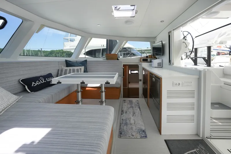 Slide: The Image of Modern yacht interior with striped seating, table, and kitchenette; Balance 482, 2022 model. - 28