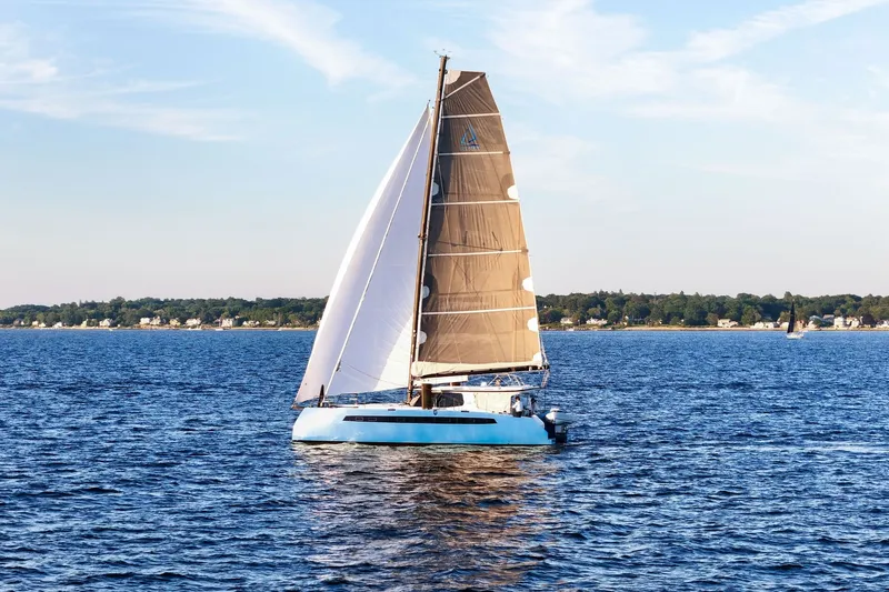 Slide: The Image of Sailboat Balance 482, 2022 model, cruising on a serene blue sea under a clear sky. - 1