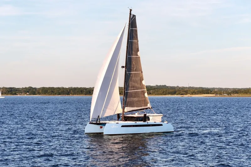 Slide: The Image of Sailing catamaran Balance 482, 2022 model, gliding on serene blue waters. - 82