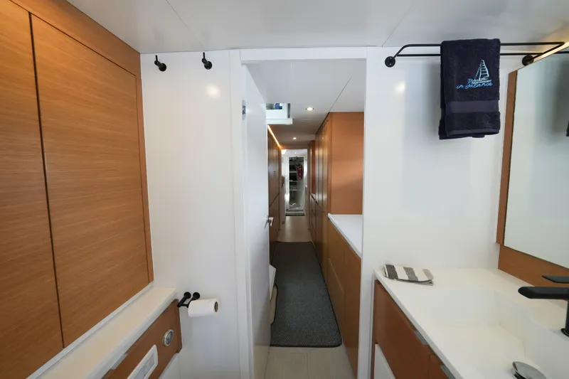 Slide: The Image of Modern yacht interior with wooden cabinets, sleek design, and towel rack. Balance 482, 2022 model. - 50
