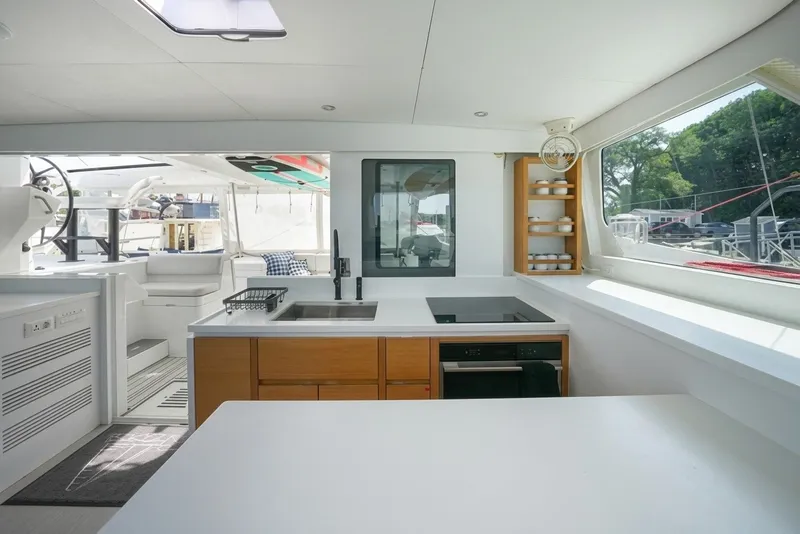 Slide: The Image of Modern yacht interior with sleek kitchen, large windows, and outdoor seating area. Balance 482, 2022 model. - 33