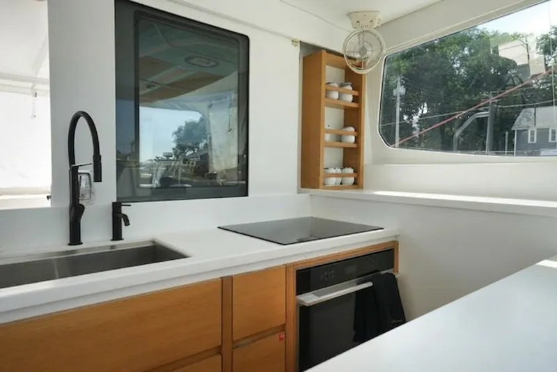 Slide: The Image of Modern kitchen interior in a 2022 Balance 482 yacht, featuring sleek design and ample natural light. - 32