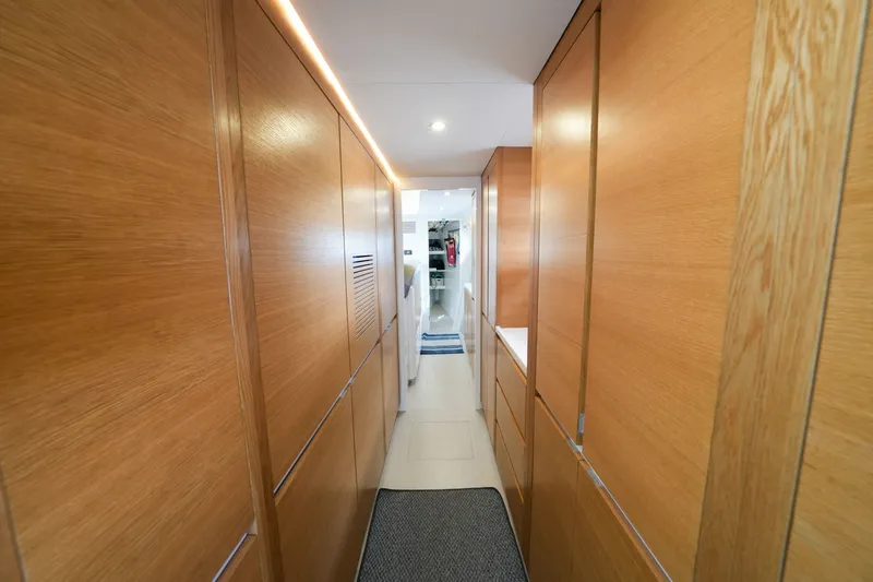 Slide: The Image of Narrow hallway with wooden paneling inside a 2022 Balance 482 model. - 38