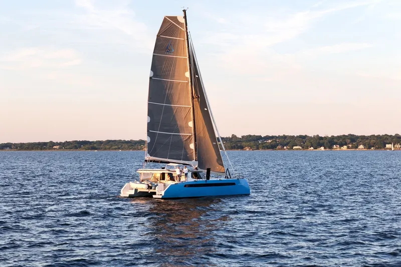 Slide: The Image of 2022 Balance 482 catamaran sailing on calm waters at sunset. - 85