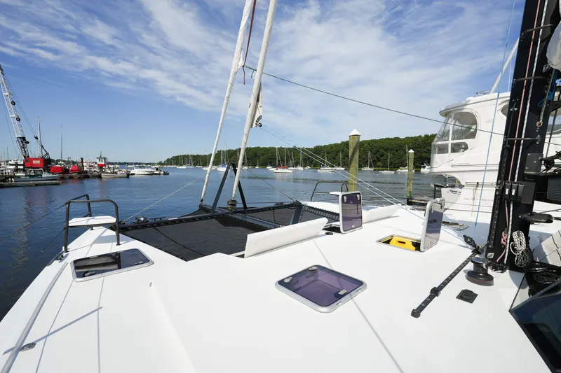 Slide: The Image of Sailing catamaran Balance 482, 2022 model, docked in a serene marina under a blue sky. - 61