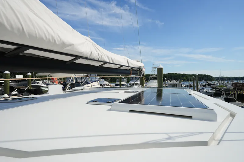 Slide: The Image of Sailboat with solar panel on deck, Balance 482 model, docked at marina, 2022. - 69