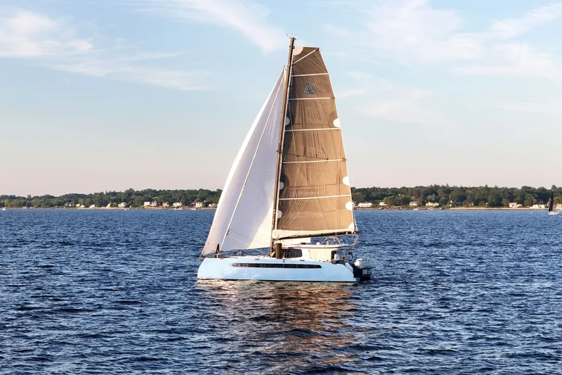 Slide: The Image of Sailing catamaran Balance 482, 2022 model, gliding on serene blue waters. - 7