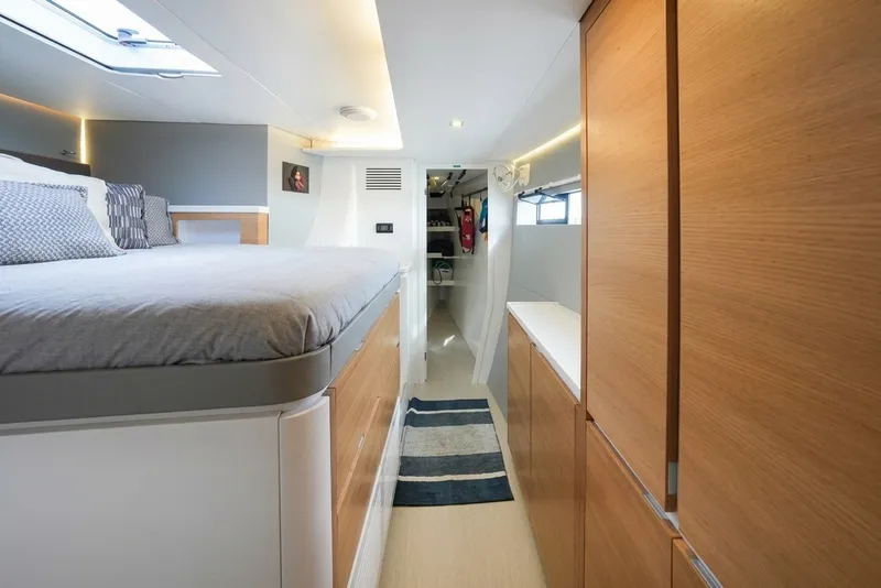Slide: The Image of Modern interior of Balance 482 yacht, featuring a cozy bedroom and sleek wooden cabinetry. - 46