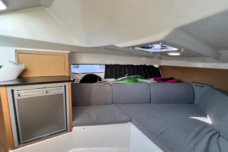 Slide: The Image of 2019 Beneteau Flyer 7.7 SPACEdeck cabin interior with seating and compact kitchenette. - 30