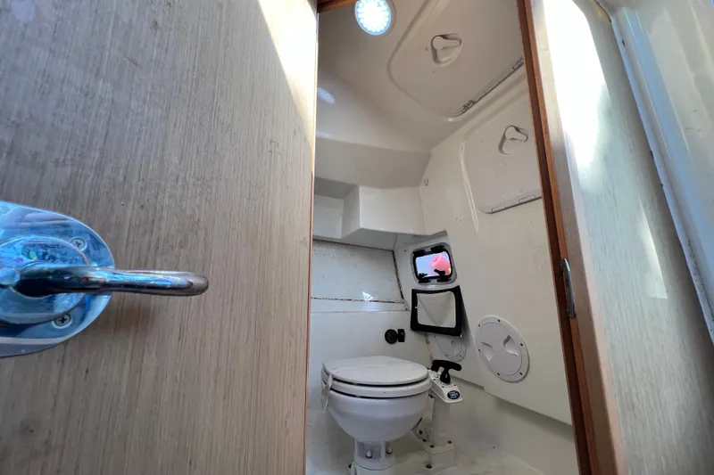 Slide: The Image of Interior view of 2019 Beneteau Flyer 7.7 SPACEdeck boat bathroom with toilet and porthole. - 28