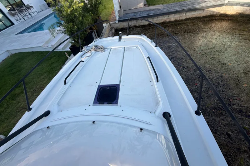 Slide: The Image of 2019 Beneteau Flyer 7.7 SPACEdeck boat docked near a poolside patio. - 20