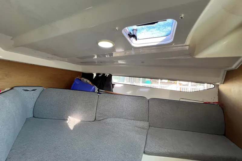 Slide: The Image of 2019 Beneteau Flyer 7.7 SPACEdeck cabin interior with gray seating and overhead hatch. - 29