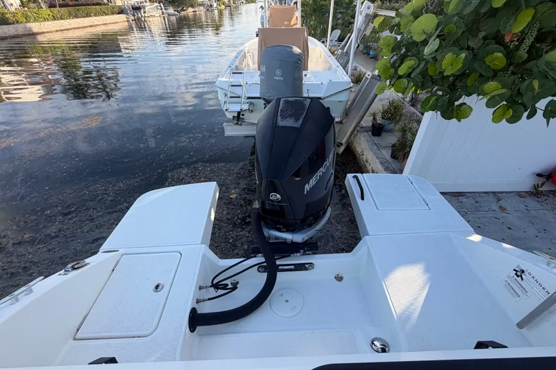 Slide: The Image of 2019 Beneteau Flyer 7.7 SPACEdeck with Mercury outboard engine, docked by a canal. - 12