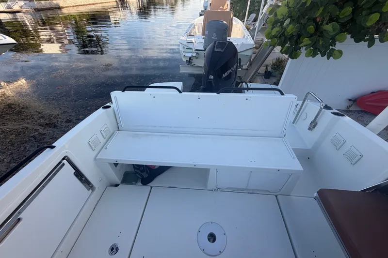 Slide: The Image of 2019 Beneteau Flyer 7.7 SPACEdeck boat with spacious seating and outboard motor, docked by water. - 34