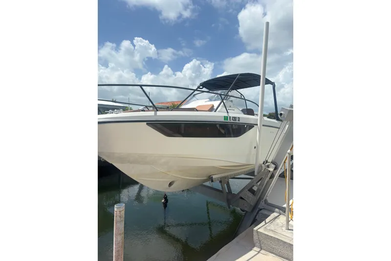 Slide: The Image of 2019 Beneteau Flyer 7.7 SPACEdeck boat on lift, under a partly cloudy sky. - 0