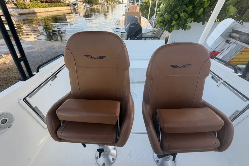 Slide: The Image of 2019 Beneteau Flyer 7.7 SPACEdeck boat with brown leather seats, docked by a canal. - 22