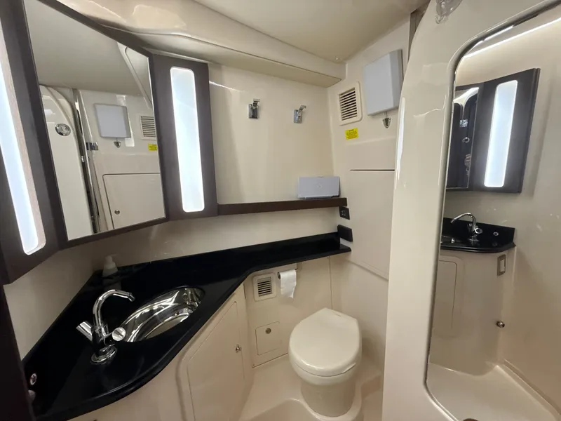 Slide: The Image of The image shows a sleek boat bathroom with a sink, toilet, and mirror. - 47