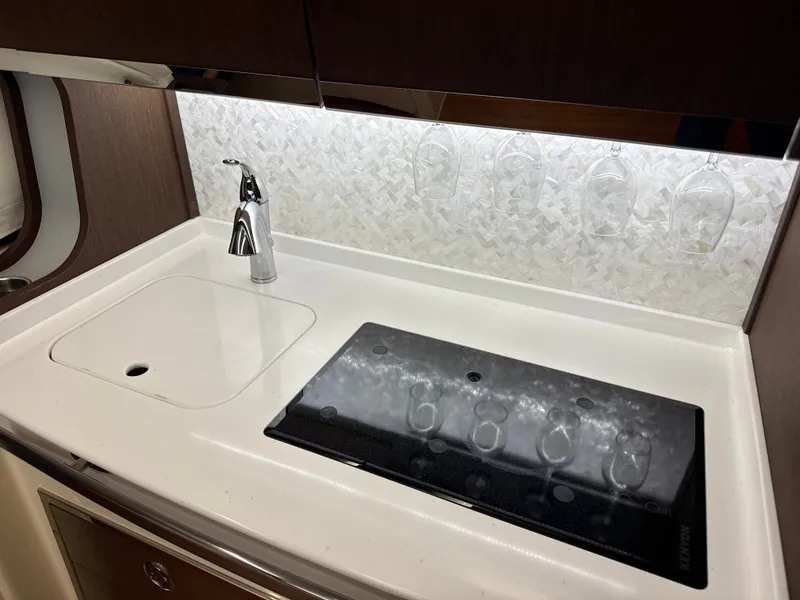 Slide: The Image of The galley of a 2020 Grady-White Canyon 456 with a sink and cooktop. - 46