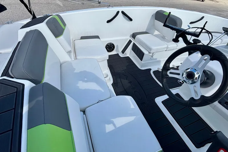 Slide: The Image of 2024 Tahoe T16 boat interior with modern seating and steering wheel design. - 9