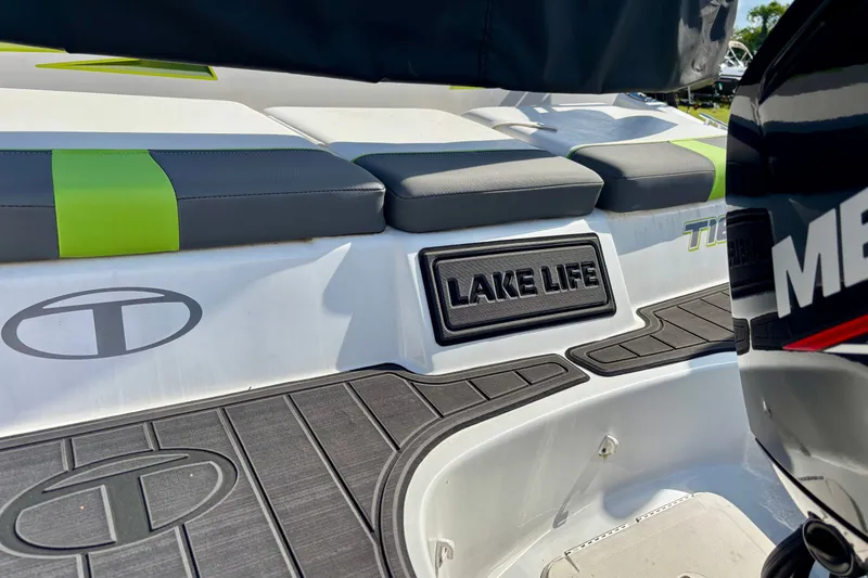 Slide: The Image of 2024 Tahoe T16 boat with "Lake Life" emblem and cushioned seating. - 11