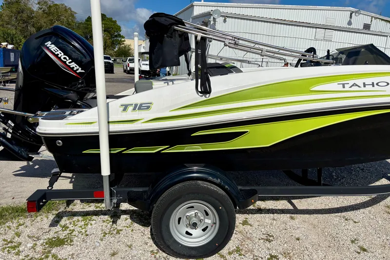 Slide: The Image of 2024 Tahoe T16 boat with Mercury engine, featuring sleek green and black design on trailer. - 6