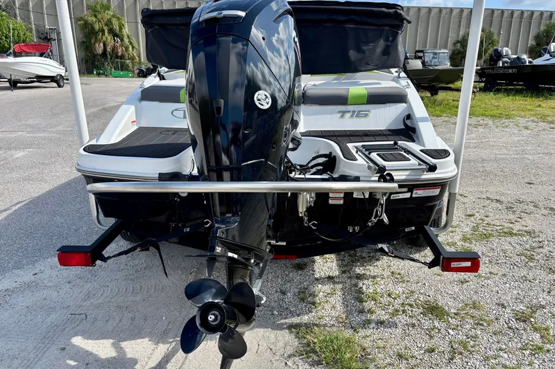 Slide: The Image of 2024 Tahoe T16 boat with outboard motor, parked on a gravel lot. - 4