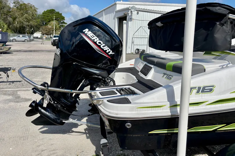 Slide: The Image of 2024 Tahoe T16 boat with Mercury outboard motor, parked outdoors. - 5